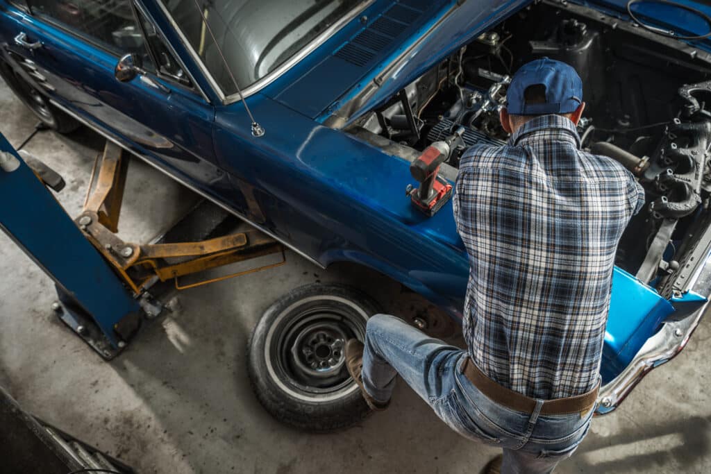 Car Mechanic in His 40s Performing Classic Car Repair